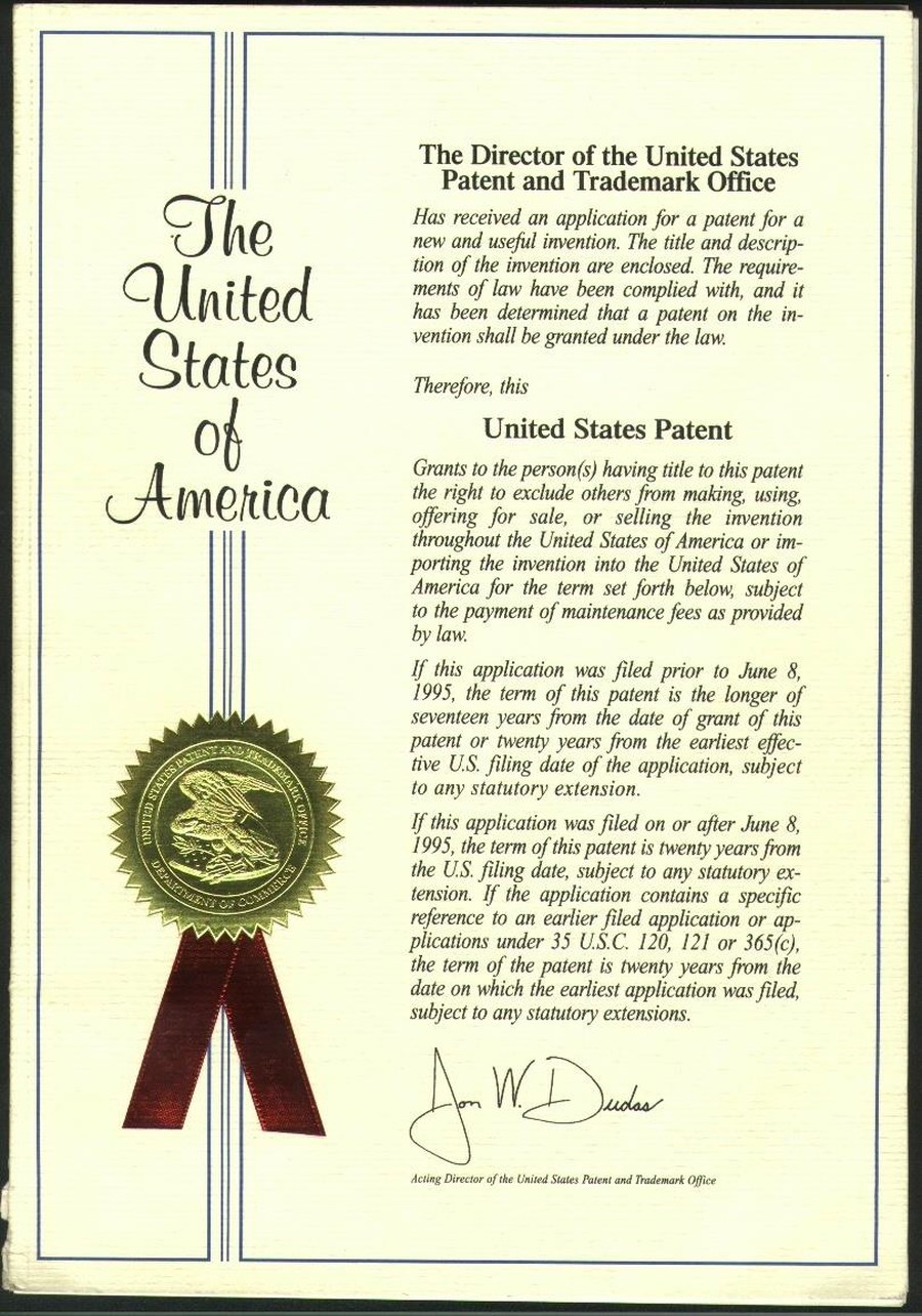 The grant certificate of the United States Patent and Trademark Office, with the gold seal and red ribbon.